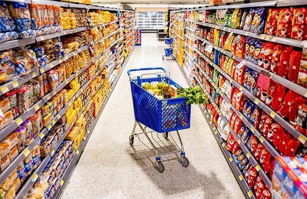 A variety of packaged food products on a supermarket shelf